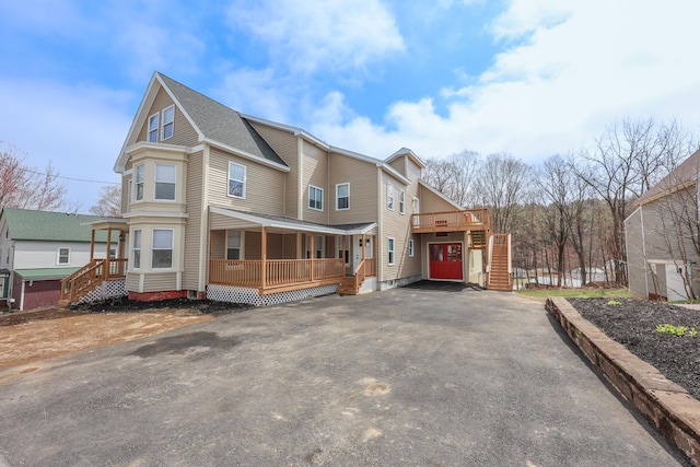 319 Mechanic St, Laconia, NH 03246 - view of home's exterior featuring a porch, asphalt driveway, stairs, and roof with shingles