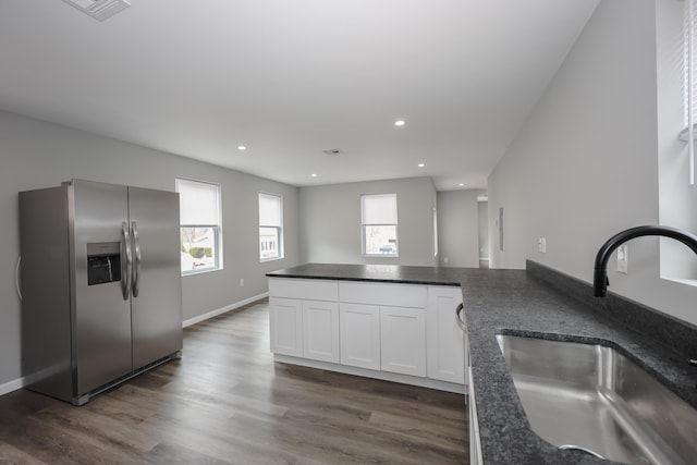319 Mechanic St, Laconia, NH 03246 - kitchen with stainless steel refrigerator with ice dispenser, a sink, white cabinetry, recessed lighting, and dark wood-style floors