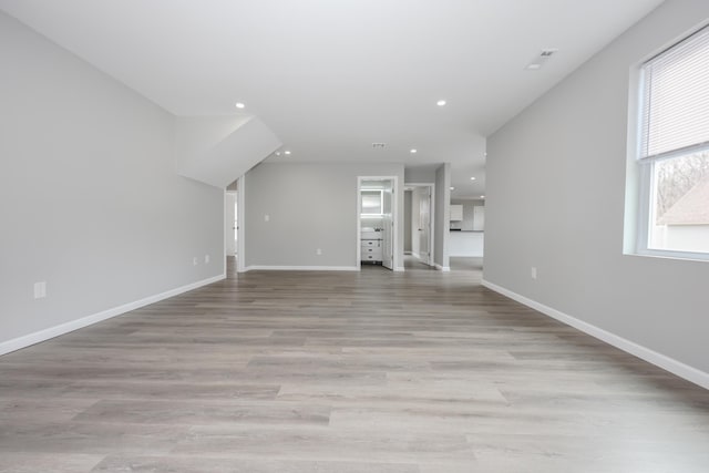 319 Mechanic St, Laconia, NH 03246 - unfurnished living room with recessed lighting, light wood-style flooring, and baseboards