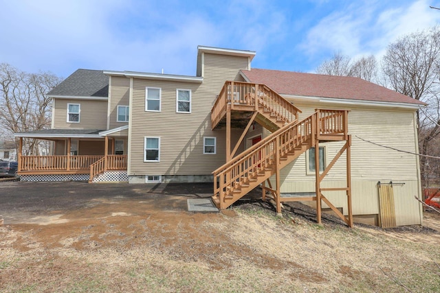 319 Mechanic St, Laconia, NH 03246 - rear view of house with stairs, roof with shingles, and a wooden deck