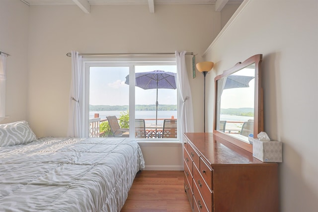 321 Webster Lake Rd, Franklin, NH 03235 - bedroom with light wood-type flooring, baseboards, beamed ceiling, and a water view