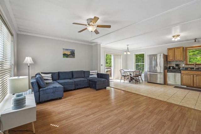 19 Wendy Dr, Alton, NH 03810 - living room featuring ornamental molding, plenty of natural light, a ceiling fan, and light wood-type flooring