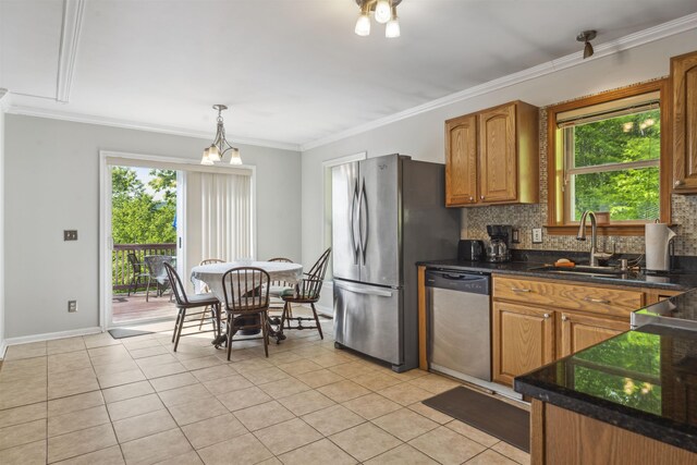 19 Wendy Dr, Alton, NH 03810 - kitchen with stainless steel appliances, light tile patterned floors, decorative backsplash, healthy amount of natural light, and ornamental molding