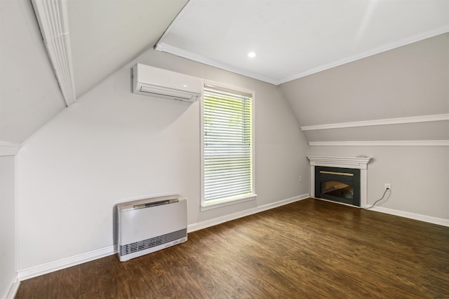 19 Wendy Dr, Alton, NH 03810 - unfurnished living room with heating unit, an AC wall unit, a glass covered fireplace, wood finished floors, and vaulted ceiling
