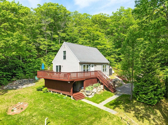 19 Wendy Dr, Alton, NH 03810 - rear view of house with stairway, a wooden deck, a lawn, a wooded view, and a shingled roof