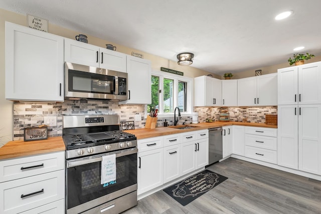 52 Meadow Ln, Belmont, NH 03220 - kitchen featuring stainless steel appliances, wooden counters, a sink, wood finished floors, and white cabinets
