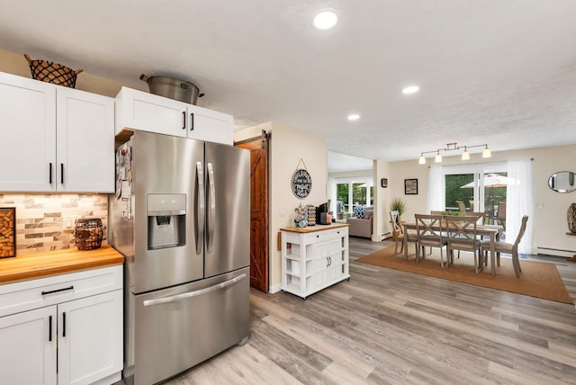 52 Meadow Ln, Belmont, NH 03220 - kitchen with stainless steel refrigerator with ice dispenser, wooden counters, a baseboard radiator, a barn door, and recessed lighting