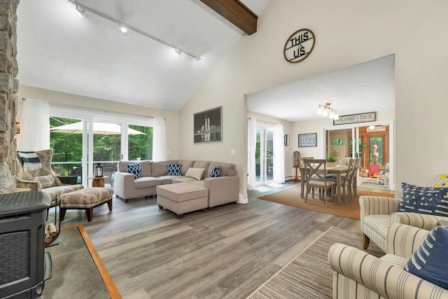 52 Meadow Ln, Belmont, NH 03220 - living room featuring track lighting, light wood-style floors, high vaulted ceiling, and beam ceiling