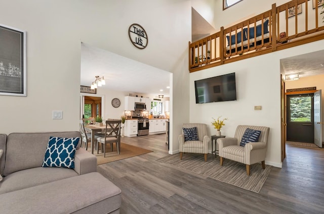 52 Meadow Ln, Belmont, NH 03220 - living room with dark wood-style flooring, plenty of natural light, a towering ceiling, and baseboards