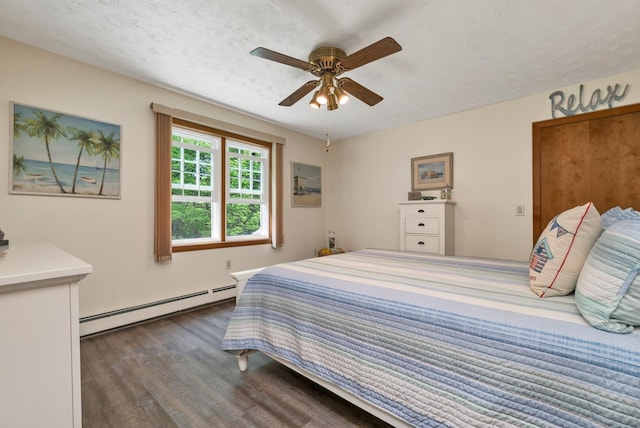 52 Meadow Ln, Belmont, NH 03220 - bedroom featuring baseboard heating, dark wood-style floors, ceiling fan, and a textured ceiling