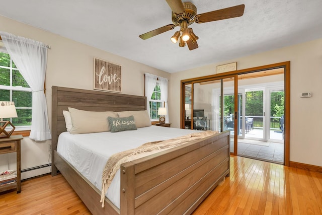 52 Meadow Ln, Belmont, NH 03220 - bedroom with access to outside, a baseboard heating unit, light wood finished floors, and baseboards