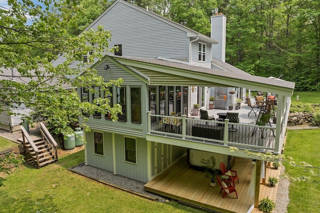 52 Meadow Ln, Belmont, NH 03220 - back of house with a chimney, a deck, a yard, and a sunroom
