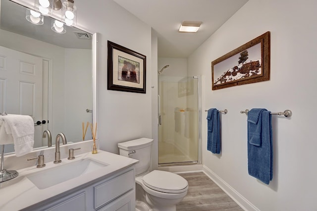 3 Sterling Hill Ln Unit 324, Exeter, NH 03833 - full bath featuring toilet, vanity, wood finished floors, a shower with shower door, and baseboards