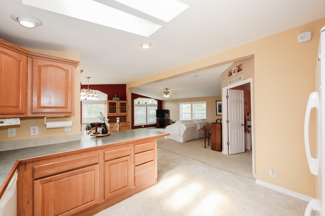 21 Mountain View Dr Unit 21, Franklin, NH 03235 - kitchen with a skylight, white dishwasher, a peninsula, open floor plan, and light carpet