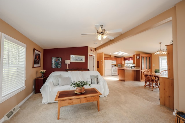 21 Mountain View Dr Unit 21, Franklin, NH 03235 - living room with vaulted ceiling, light carpet, a chandelier, ceiling fan, and baseboards