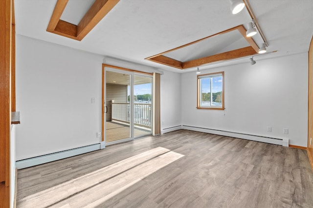 68 Kings Hwy Unit 23, Hampton, NH 03842 - empty room with baseboard heating, wood finished floors, rail lighting, and baseboards