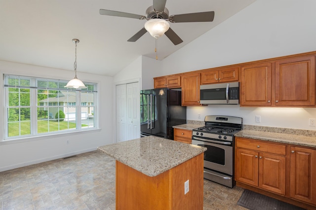 15 Christopher Dr Unit 5, Sandown, NH 03873 - kitchen with appliances with stainless steel finishes, vaulted ceiling, brown cabinets, light stone counters, and a kitchen island