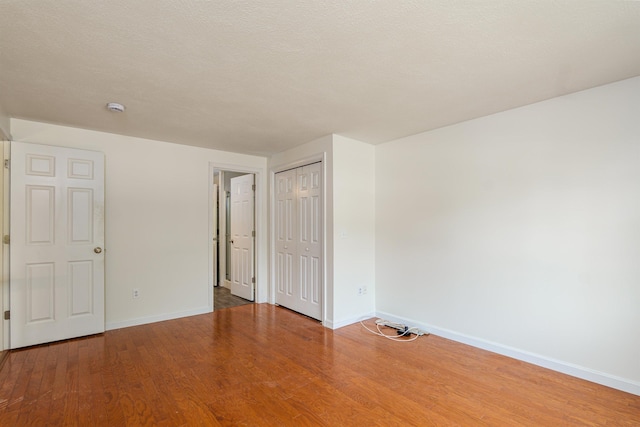 15 Christopher Dr Unit 5, Sandown, NH 03873 - unfurnished bedroom with baseboards, wood finished floors, and a closet