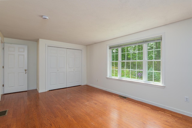 15 Christopher Dr Unit 5, Sandown, NH 03873 - unfurnished bedroom featuring baseboards, wood finished floors, and a closet