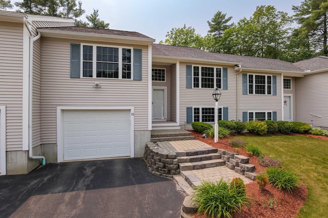 15 Christopher Dr Unit 5, Sandown, NH 03873 - raised ranch featuring a garage, a front lawn, and asphalt driveway