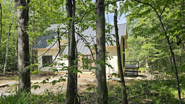 209 Craney Hill Rd, Henniker, NH 03242 - view of side of property with a standing seam roof, metal roof, and stucco siding