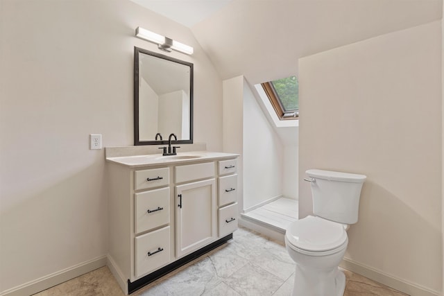 209 Craney Hill Rd, Henniker, NH 03242 - bathroom featuring toilet, a skylight, vanity, vaulted ceiling, and baseboards