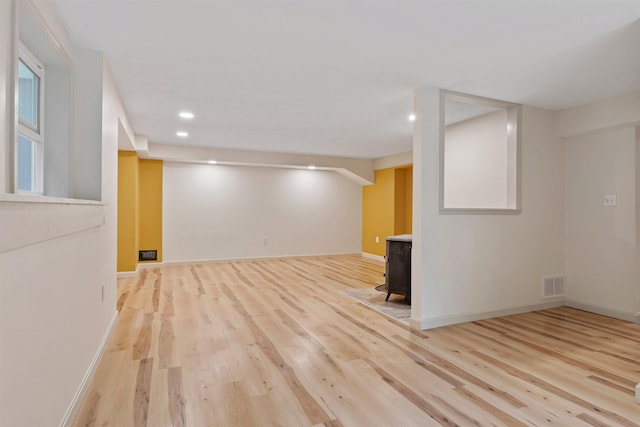 209 Craney Hill Rd, Henniker, NH 03242 - finished below grade area featuring a wood stove, wood finished floors, recessed lighting, and baseboards