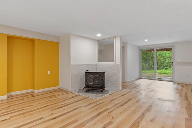 209 Craney Hill Rd, Henniker, NH 03242 - unfurnished living room featuring a wood stove, wood finished floors, baseboards, and recessed lighting