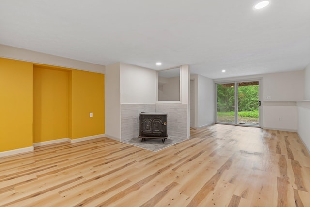 209 Craney Hill Rd, Henniker, NH 03242 - unfurnished living room featuring a wood stove, wood finished floors, recessed lighting, and baseboards