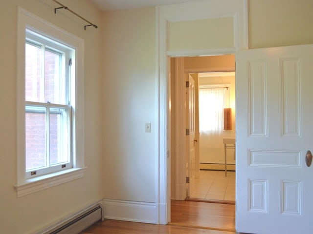 406 Dalton Dr Unit D, Colchester, VT 05446 - hall featuring baseboard heating, healthy amount of natural light, a baseboard heating unit, and wood finished floors