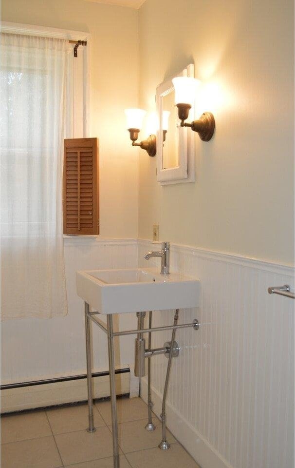 406 Dalton Dr Unit D, Colchester, VT 05446 - bathroom with a wainscoted wall, a baseboard heating unit, and tile patterned flooring