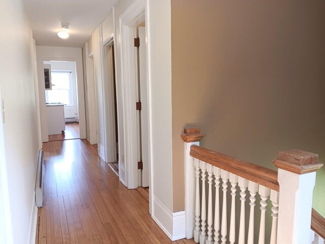 406 Dalton Dr Unit D, Colchester, VT 05446 - hall with light wood-style floors, a baseboard heating unit, and baseboards