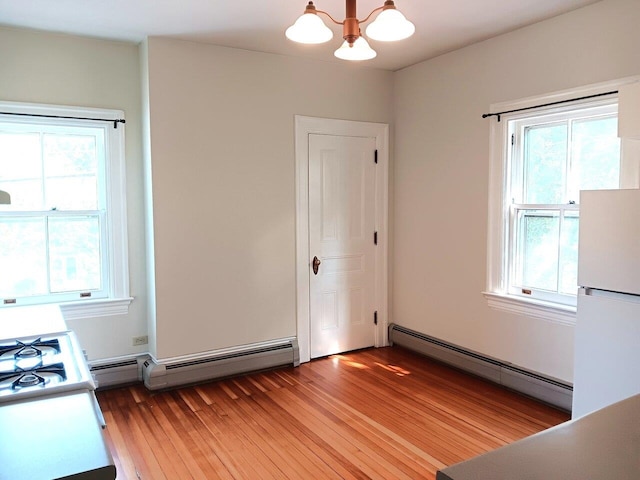 406 Dalton Dr Unit D, Colchester, VT 05446 - unfurnished bedroom featuring a baseboard heating unit, freestanding refrigerator, a chandelier, and multiple windows