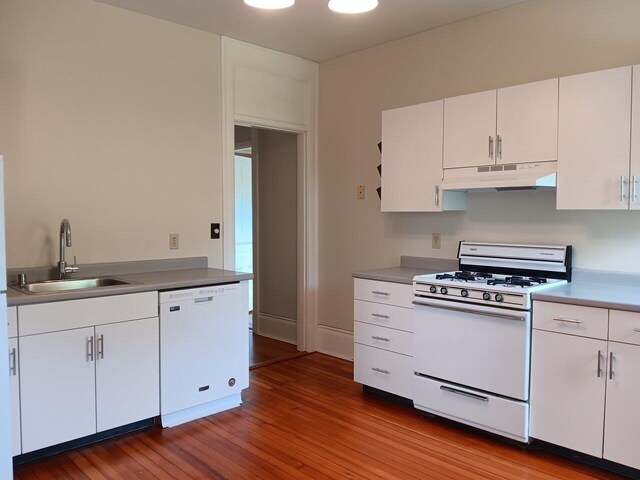 406 Dalton Dr Unit D, Colchester, VT 05446 - kitchen with white appliances, a sink, under cabinet range hood, wood finished floors, and white cabinets