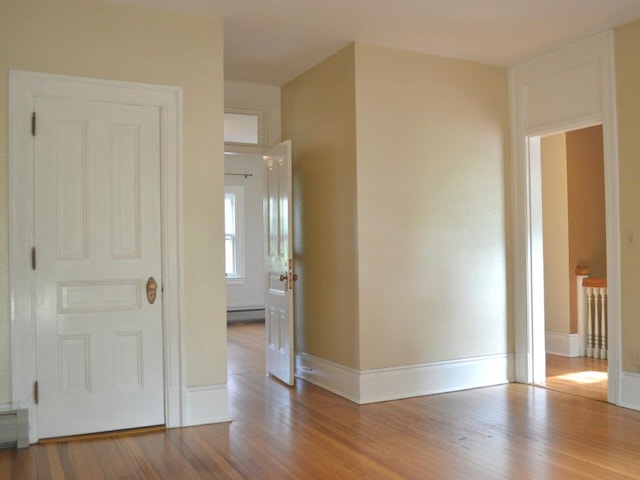 406 Dalton Dr Unit D, Colchester, VT 05446 - empty room featuring wood finished floors, a baseboard radiator, and baseboards