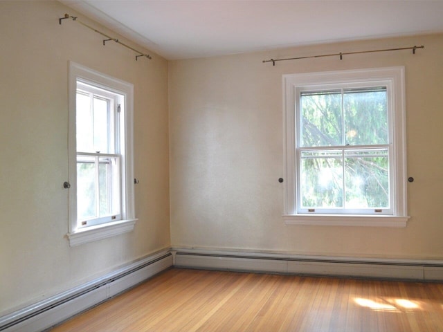406 Dalton Dr Unit D, Colchester, VT 05446 - spare room with a baseboard radiator and light wood-style flooring