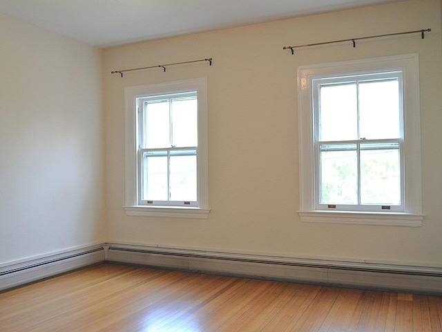 406 Dalton Dr Unit D, Colchester, VT 05446 - spare room with baseboard heating, healthy amount of natural light, and wood finished floors