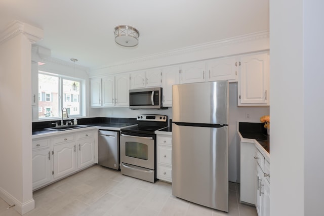 4 Kimberly Dr Unit 4, Merrimack, NH 03054 - kitchen with appliances with stainless steel finishes, white cabinets, a sink, dark countertops, and pendant lighting