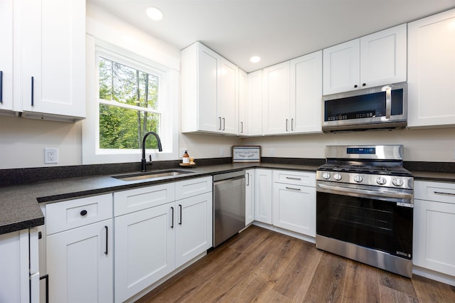 80 Scott Dr, Alton, NH 03810 - kitchen featuring stainless steel appliances, a sink, recessed lighting, dark countertops, and white cabinets