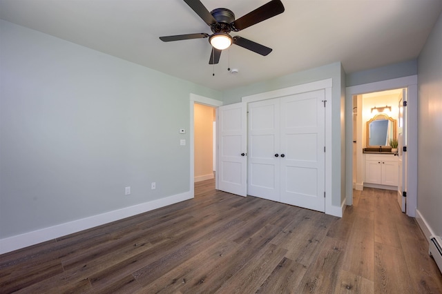 80 Scott Dr, Alton, NH 03810 - unfurnished bedroom featuring baseboards, wood finished floors, a closet, a baseboard radiator, and a ceiling fan