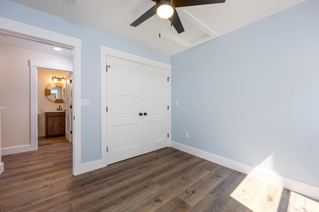 80 Scott Dr, Alton, NH 03810 - unfurnished bedroom with dark wood-style floors, a closet, baseboards, and a ceiling fan