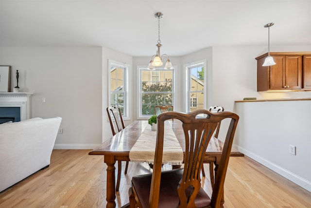 67 Leddy Dr, Epping, NH 03042 - dining area featuring light wood-style floors, baseboards, and a fireplace