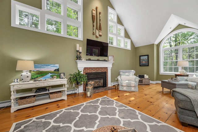 12 Ridgewood Ter, Exeter, NH 03833 - living area featuring hardwood / wood-style floors, high vaulted ceiling, a fireplace, and baseboard heating