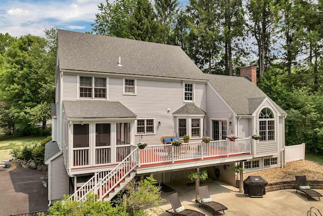 12 Ridgewood Ter, Exeter, NH 03833 - rear view of house featuring a patio area, a deck, a chimney, and roof with shingles
