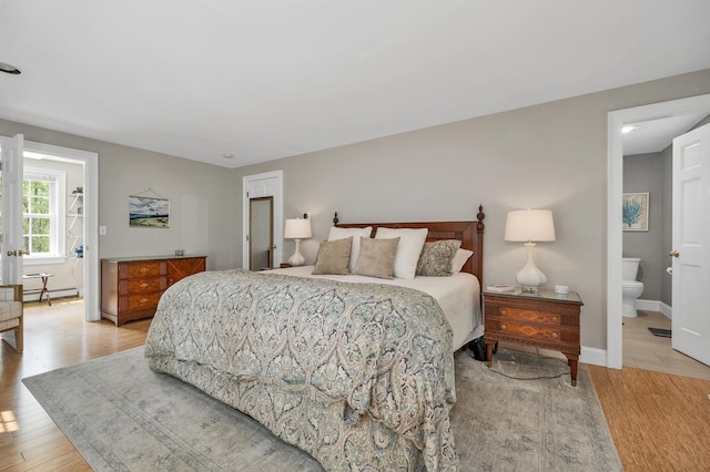 12 Ridgewood Ter, Exeter, NH 03833 - bedroom featuring a baseboard radiator, light wood finished floors, and baseboards