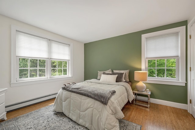 12 Ridgewood Ter, Exeter, NH 03833 - bedroom featuring a baseboard radiator, wood finished floors, and baseboards