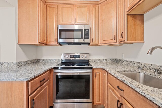 144 Treetop Cir Unit 15, Laconia, NH 03246 - kitchen featuring stainless steel appliances, a sink, light stone counters, and light brown cabinets