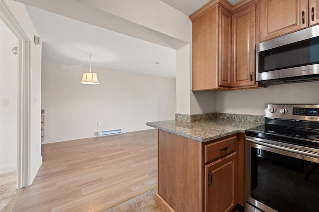 144 Treetop Cir Unit 15, Laconia, NH 03246 - kitchen featuring appliances with stainless steel finishes, a baseboard radiator, brown cabinets, and light wood-type flooring