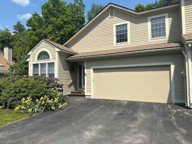 60 Skyline Dr, Keene, NH 03431 - view of front of home with an attached garage, asphalt driveway, and roof with shingles