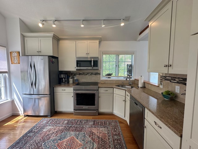 60 Skyline Dr, Keene, NH 03431 - kitchen with stainless steel appliances, a sink, light wood-type flooring, and dark stone countertops